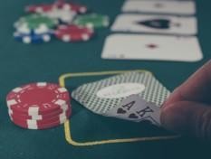 Pelikortteja ja pelimerkkejä kasinopöydällä.