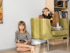 Two children playing video games.