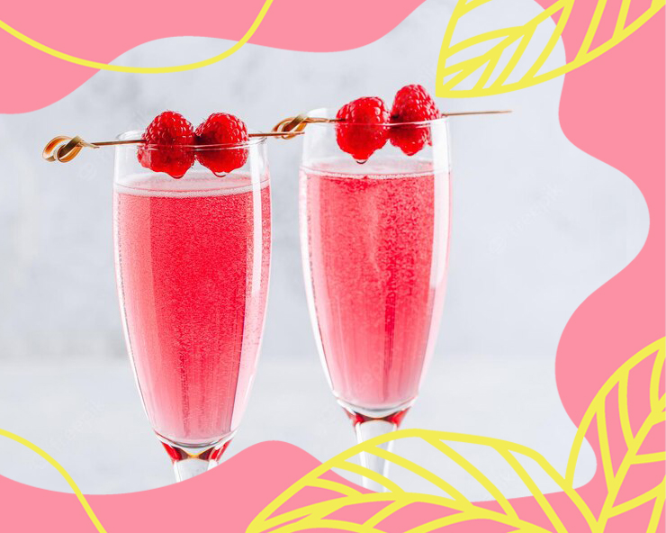 Kaksi kuohuviinlasia, joissa pinkkiä juomaa ja vadelmat koristeina.